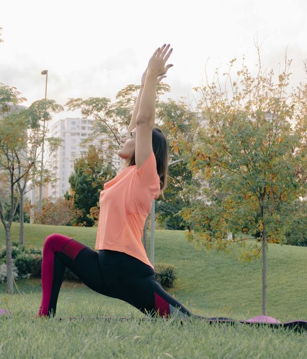 Woman in a calm yoga pose, embodying harmony and flexibility.